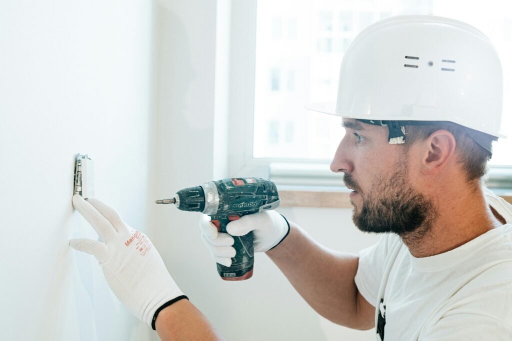 someone drilling into a structural wall