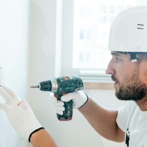 someone drilling into a structural wall